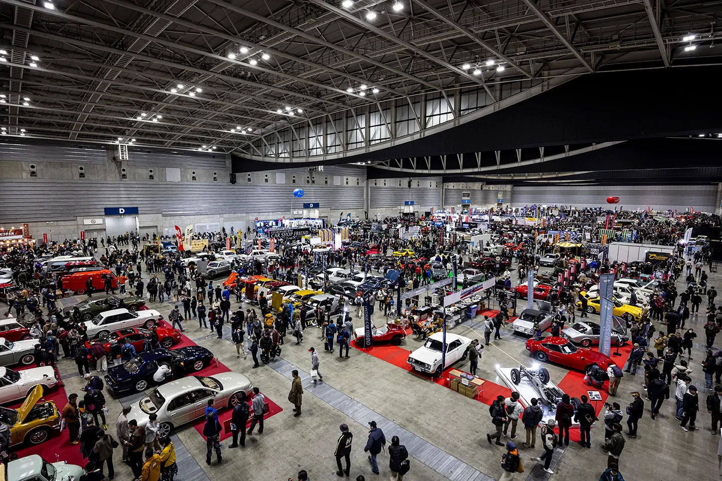 車両や出展ブースが並び、多くの来場者でにぎわう過去開催の会場